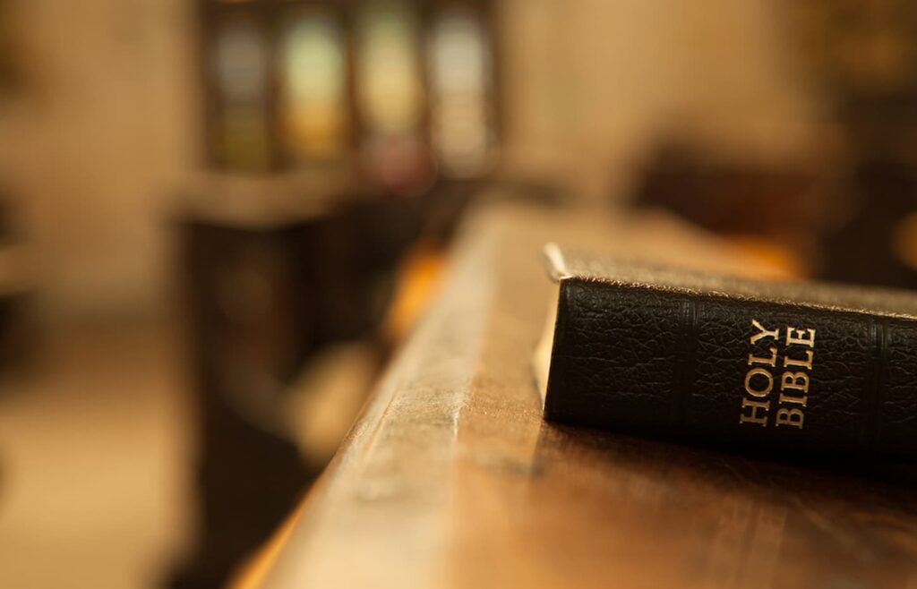 An image of the Holy bible on a wooden table.