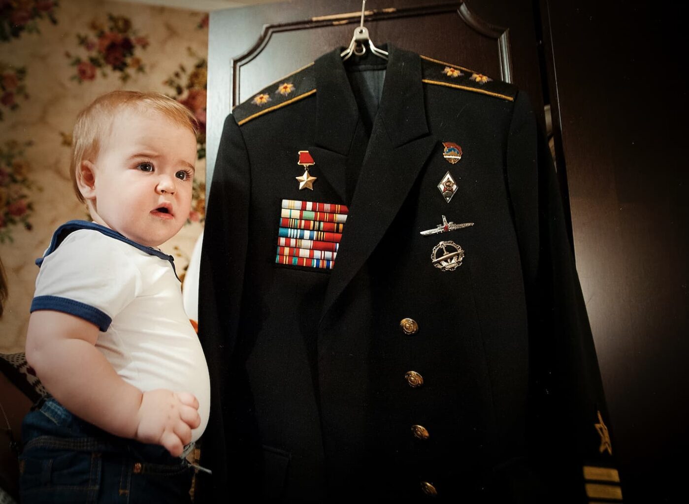 An image of a little girl with a great-grandfather's uniform.