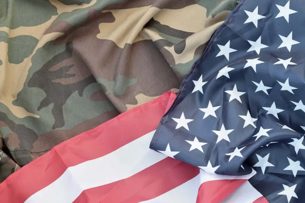 An image of United States of America flag and folded military uniform jacket.