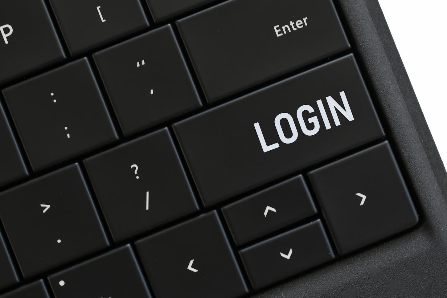 An image of a Login button on a computer keyboard for accessing your account online on a website.