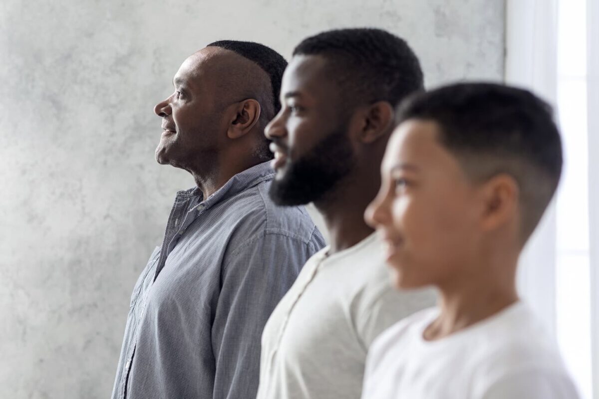 An image of s Multigenerational Men Family Portrait. Black Son, Father, And Grandfather Standing In Row.
